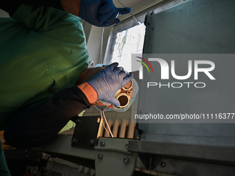 A chemist is looking into the dehydration furnace during the production of medicinal hydrogel dressings for Ukrainian soldiers at Lviv Polyt...