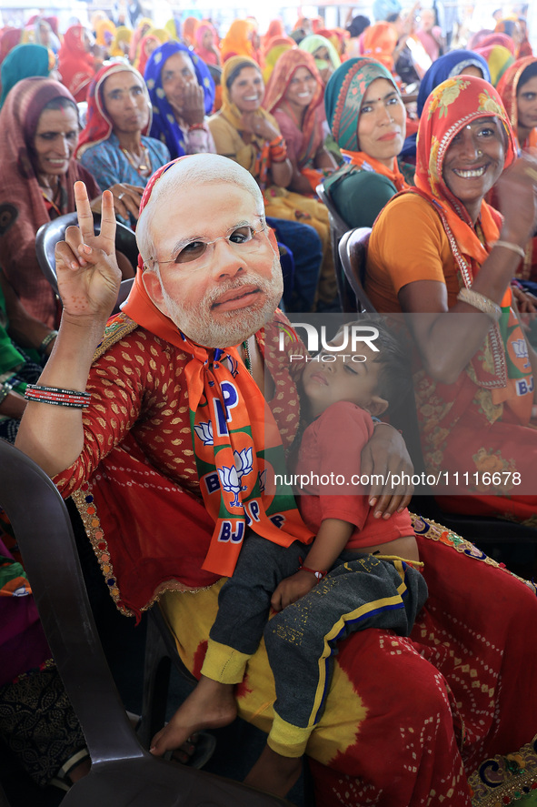 In Jaipur, Rajasthan, India, on April 2, 2024, BJP supporters are wearing face masks of PM Narendra Modi during a public meeting ahead of th...