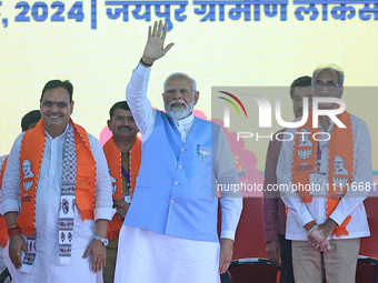 Prime Minister Narendra Modi is with Rajasthan Chief Minister Bhajan Lal Sharma, showing support for BJP Jaipur Rural candidate Rao Rajendra...