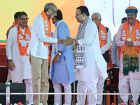 Rajasthan Chief Minister Bhajan Lal Sharma is with BJP Jaipur Rural candidate Rao Rajendra Singh (L) at a public meeting ahead of the Lok Sa...