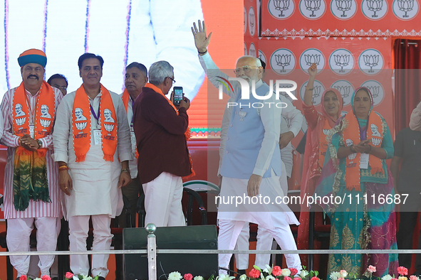 Prime Minister Narendra Modi is showing his support for BJP Jaipur Rural candidate Rao Rajendra Singh during a public meeting ahead of the L...