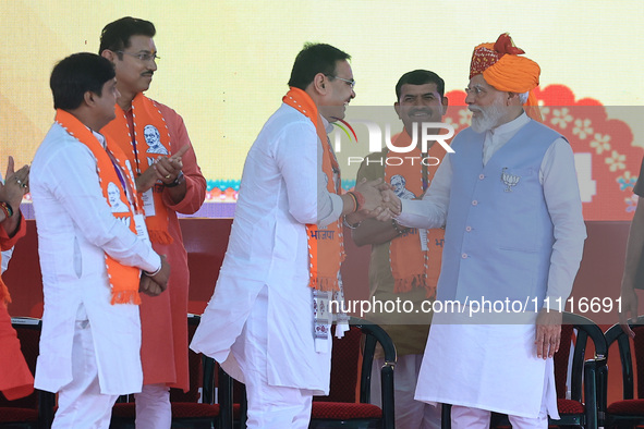 Prime Minister Narendra Modi is with Rajasthan Chief Minister Bhajan Lal Sharma during the public meeting ahead of the Lok Sabha election, i...