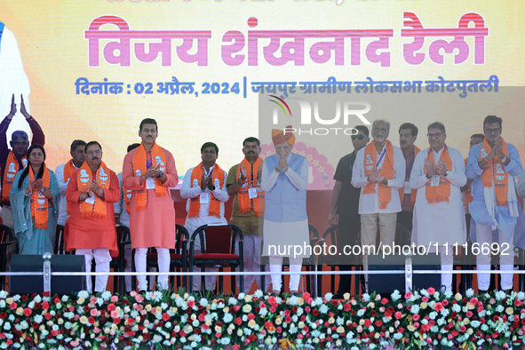 Prime Minister Narendra Modi is with party leaders during a public meeting ahead of the Lok Sabha election in Kotputali, Jaipur, Rajasthan,...