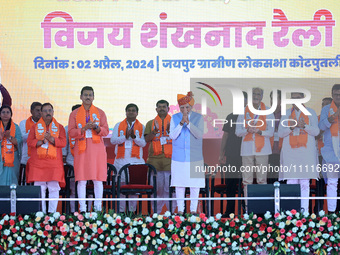 Prime Minister Narendra Modi is with party leaders during a public meeting ahead of the Lok Sabha election in Kotputali, Jaipur, Rajasthan,...