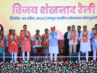 Prime Minister Narendra Modi is with party leaders during a public meeting ahead of the Lok Sabha election in Kotputali, Jaipur, Rajasthan,...