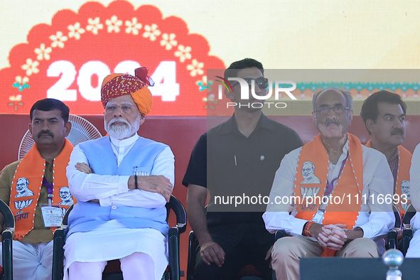 Prime Minister Narendra Modi is with BJP Jaipur Rural candidate Rao Rajendra Singh (R) at a public meeting ahead of the Lok Sabha election i...