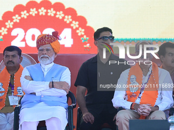 Prime Minister Narendra Modi is with BJP Jaipur Rural candidate Rao Rajendra Singh (R) at a public meeting ahead of the Lok Sabha election i...