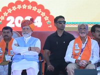 Prime Minister Narendra Modi is with BJP Jaipur Rural candidate Rao Rajendra Singh (R) at a public meeting ahead of the Lok Sabha election i...