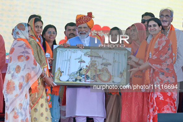 Prime Minister Narendra Modi is being welcomed by party women leaders during the public meeting ahead of the Lok Sabha election in Kotputali...