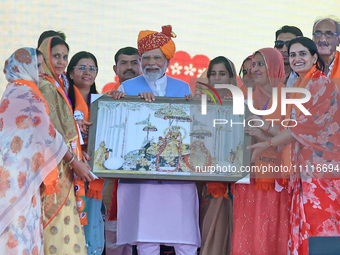 Prime Minister Narendra Modi is being welcomed by party women leaders during the public meeting ahead of the Lok Sabha election in Kotputali...