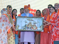 Prime Minister Narendra Modi is being welcomed by party women leaders during the public meeting ahead of the Lok Sabha election in Kotputali...