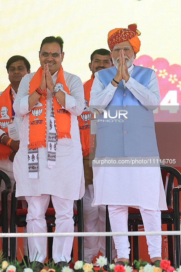 Prime Minister Narendra Modi is with Rajasthan Chief Minister Bhajan Lal Sharma at a public meeting ahead of the Lok Sabha election in Kotpu...