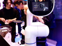 A robotic arm is displaying V.Stella, a Generative AI Hardware with a virtual assistant, at the SK Telecom pavilion at the Mobile World Cong...