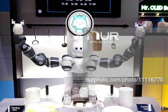 A robot with two arms is performing a MIL-STD-810G test on a Samsung Galaxy Z Flip 5 at the Samsung Display pavilion during the Mobile World...