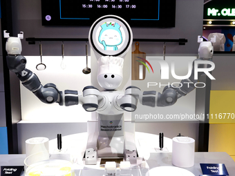 A robot with two arms is performing a MIL-STD-810G test on a Samsung Galaxy Z Flip 5 at the Samsung Display pavilion during the Mobile World...