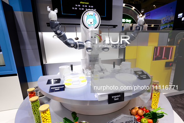 A robot with two arms is performing a MIL-STD-810G test on a Samsung Galaxy Z Flip 5 at the Samsung Display pavilion during the Mobile World...