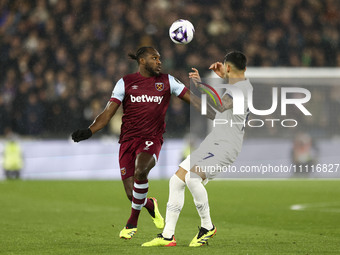 Michail Antonio of West Ham United is battling with Pedro Porro of Tottenham Hotspur for the ball during the Premier League match between We...