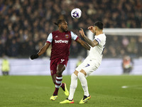 Michail Antonio of West Ham United is battling with Pedro Porro of Tottenham Hotspur for the ball during the Premier League match between We...