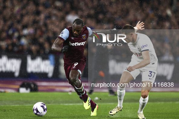 Michail Antonio of West Ham United is on the ball, being tracked by Micky Van De Ven of Tottenham Hotspur, during the Premier League match b...