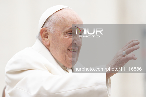 Pope Francis is gesturing as he arrives to lead the weekly general audience in St. Peter's Square at the Vatican on April 3, 2024. 