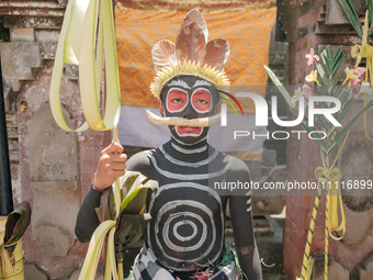 Children are joining the spectacle, their faces and bodies painted to embody mythical beings, adding a playful spirit to the ceremony, on Ap...