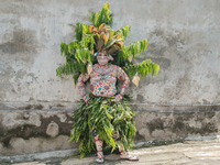 Gede Pasek, aged 32, is adorning himself with colors and patterns that mimic the lush forests of Bali, symbolizing the mystical hideaways of...