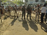 Security personnel are standing guard outside the deputy commissioner's office where All India United Democratic Front (AIUDF) candidate Ami...