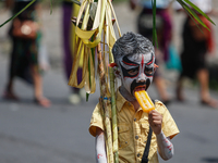 A Balinese child with a painted body is marching as they attend the Ngerebeg tradition in Tegallalang Village, Bali, Indonesia, on April 3,...