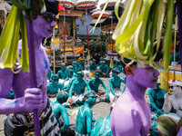 Balinese men with painted bodies are waiting as they attend the Ngerebeg tradition in Tegallalang Village, Bali, Indonesia, on April 3, 2024...