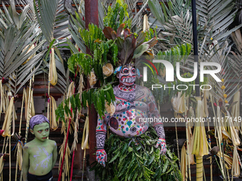 Balinese men with painted bodies are waiting as they attend the Ngerebeg tradition in Tegallalang Village, Bali, Indonesia, on April 3, 2024...