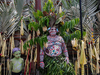 Balinese men with painted bodies are waiting as they attend the Ngerebeg tradition in Tegallalang Village, Bali, Indonesia, on April 3, 2024...