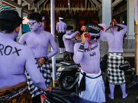 Balinese men with painted bodies are preparing to attend the Ngerebeg tradition in Tegallalang Village, Bali, Indonesia, on April 3, 2024. N...