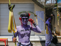 Balinese men with painted bodies are preparing to attend the Ngerebeg tradition in Tegallalang Village, Bali, Indonesia, on April 3, 2024. N...