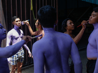 Balinese men are being painted before they attend the Ngerebeg tradition in Tegallalang Village, Bali, Indonesia, on April 3, 2024. Ngerebeg...