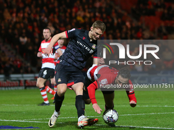Sam Dalby of Wrexham is fouling Jamie Sterry of Doncaster Rovers during the Sky Bet League 2 match between Doncaster Rovers and Wrexham at t...