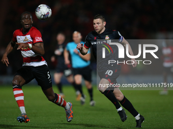 Paul Mullin of Wrexham is chasing down a ball during the Sky Bet League 2 match between Doncaster Rovers and Wrexham at the Keepmoat Stadium...