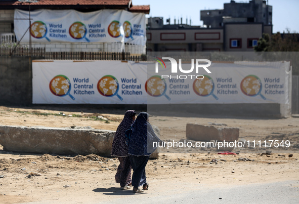 Palestinians are walking in front of the closed headquarters of the World Central Kitchen two days after a convoy of the NGO was hit in an I...