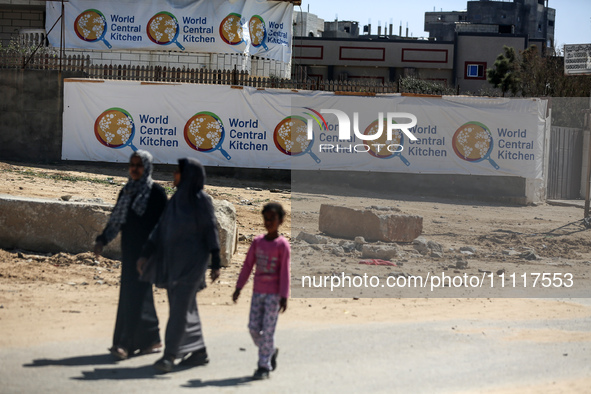 Palestinians are walking in front of the closed headquarters of the World Central Kitchen two days after a convoy of the NGO was hit in an I...