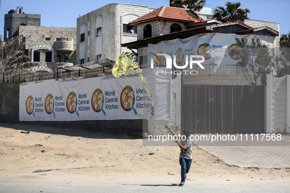 A Palestinian boy is playing in front of the closed headquarters of the World Central Kitchen two days after a convoy of the NGO was hit in...