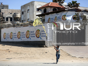 A Palestinian boy is playing in front of the closed headquarters of the World Central Kitchen two days after a convoy of the NGO was hit in...