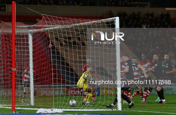 Paul Mullin of Wrexham is scoring a goal that is being disallowed during the Sky Bet League 2 match between Doncaster Rovers and Wrexham at...