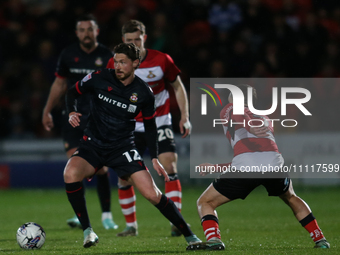 George Evans of Wrexham is taking on the Doncaster Rovers' defense during the Sky Bet League 2 match between Doncaster Rovers and Wrexham at...