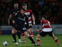 George Evans of Wrexham is taking on the Doncaster Rovers' defense during the Sky Bet League 2 match between Doncaster Rovers and Wrexham at...