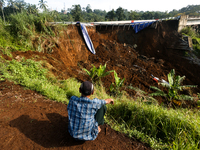 Residents are sitting and looking at the Bogor-Ciawi-Sukabumi (Bocimi) Toll Road after it was hit by a landslide in Bogor, Indonesia, on Apr...