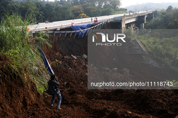 Journalists are photographing the Bogor-Ciawi-Sukabumi (Bocimi) toll road after it was hit by a landslide in Bogor, Indonesia, on April 4, 2...