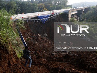 Journalists are photographing the Bogor-Ciawi-Sukabumi (Bocimi) toll road after it was hit by a landslide in Bogor, Indonesia, on April 4, 2...