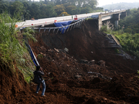 Journalists are photographing the Bogor-Ciawi-Sukabumi (Bocimi) toll road after it was hit by a landslide in Bogor, Indonesia, on April 4, 2...