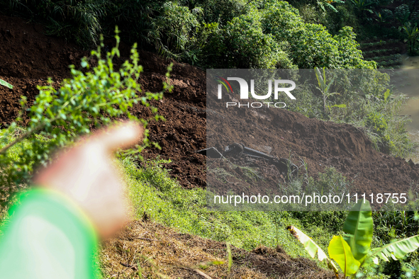 A car is plunging into a ravine after a landslide disaster on the Bogor-Ciawi-Sukabumi (Bocimi) toll road in Bogor, Indonesia, on April 4, 2...