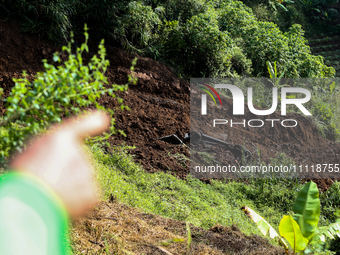 A car is plunging into a ravine after a landslide disaster on the Bogor-Ciawi-Sukabumi (Bocimi) toll road in Bogor, Indonesia, on April 4, 2...