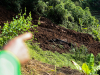 A car is plunging into a ravine after a landslide disaster on the Bogor-Ciawi-Sukabumi (Bocimi) toll road in Bogor, Indonesia, on April 4, 2...